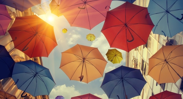 Kuvituskuva värikkäistä sateenvarjoista